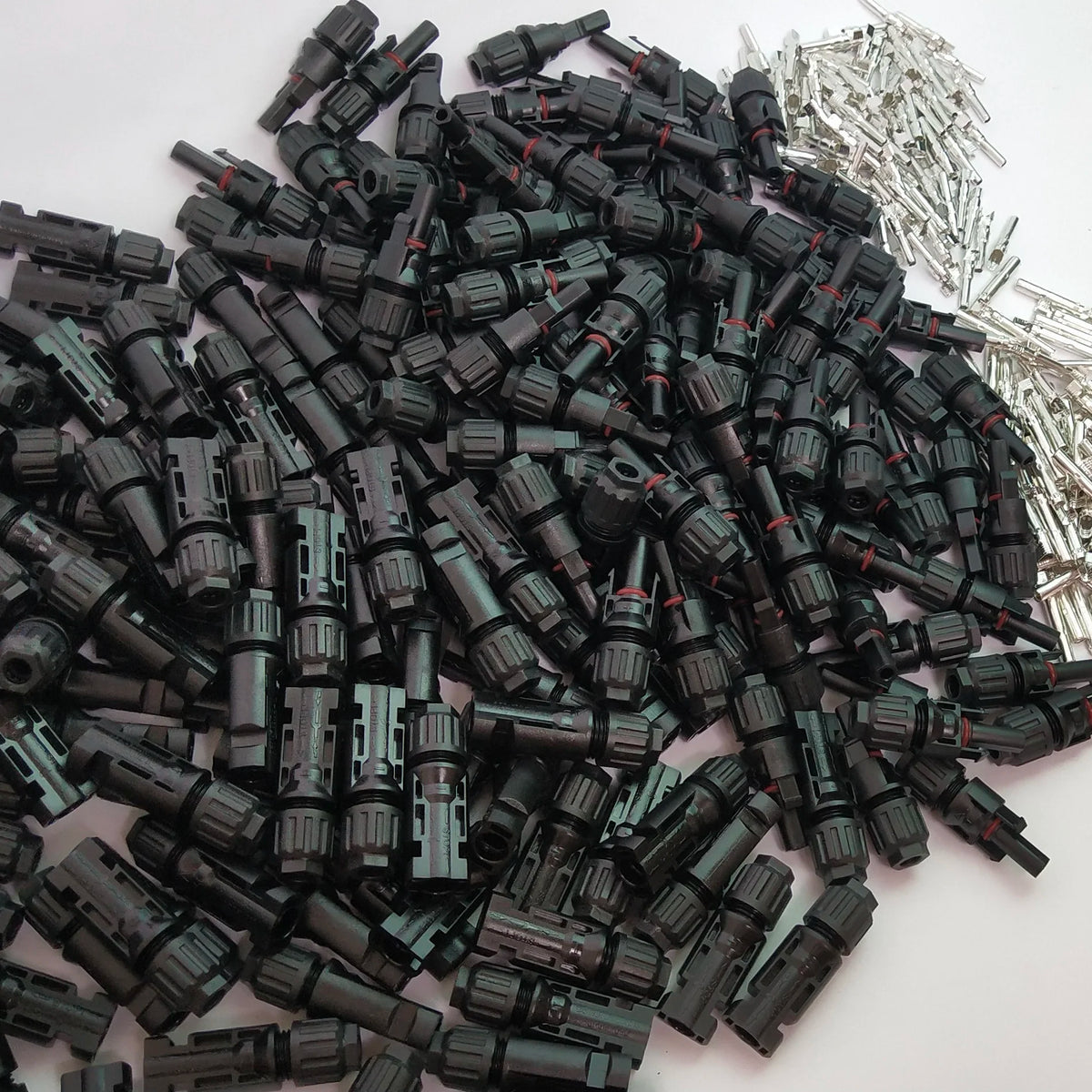Pile of black plastic connectors on a white background
