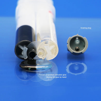 A close-up of a syringe-like applicator with its cap removed, showing a clear plastic body and black plunger, placed on a blue reflective surface. A separate matching cap sits to the right with a label pointing to it as a &