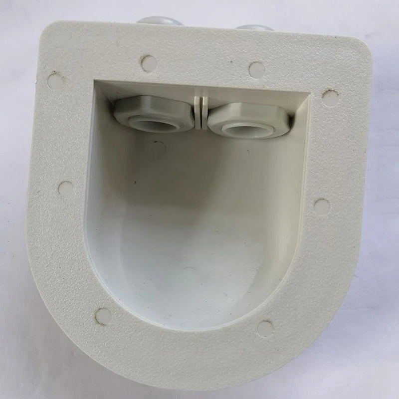 An off-white plastic electrical junction box or socket cover with two terminal connectors visible inside, photographed on a light background.